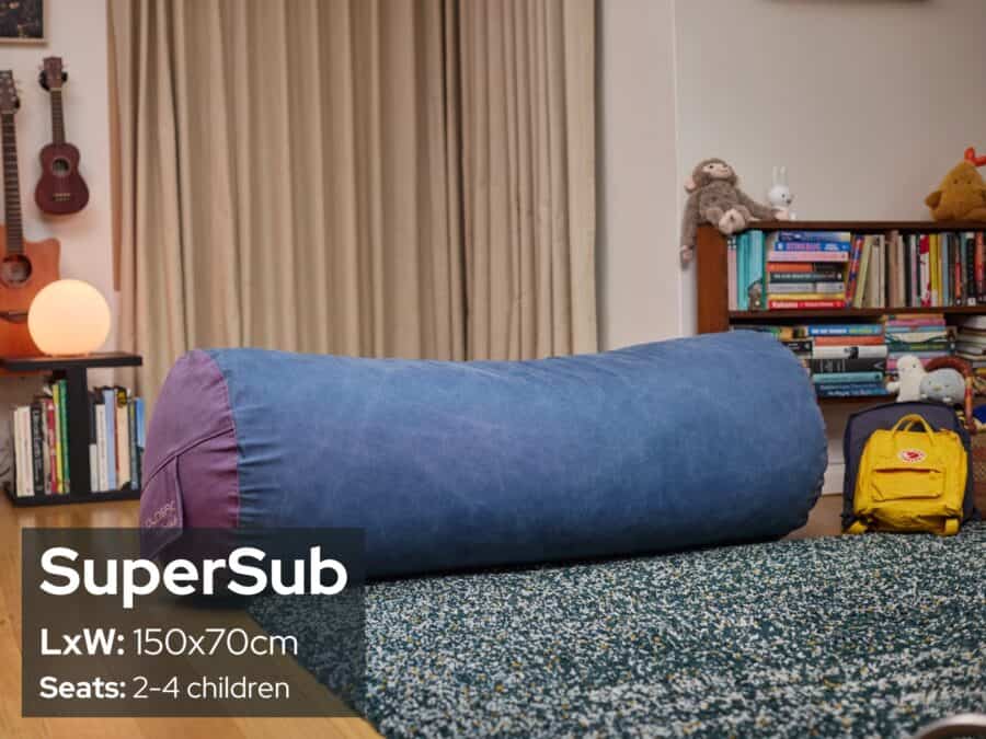 Large blue foam filled SuperSub bean bag in a cozy living room setting.