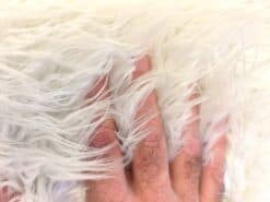 Shaggy White Faux Fur close up - hand